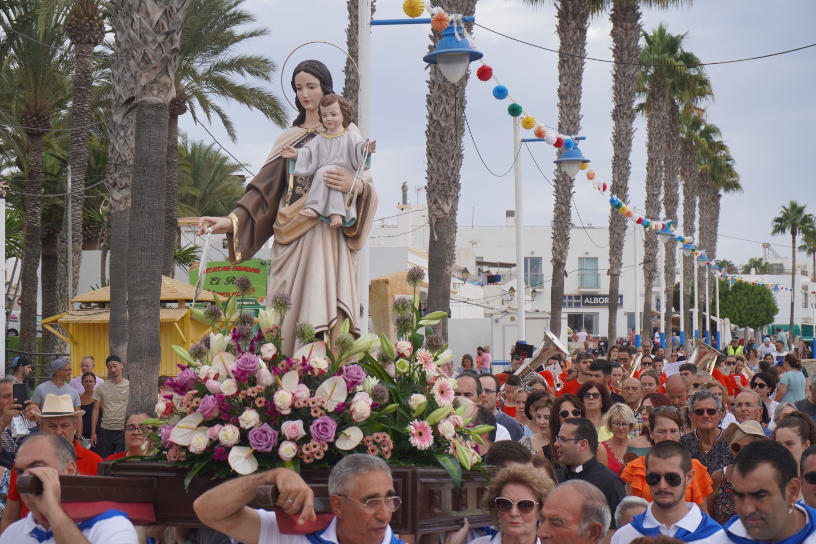 Procession of the Virgen del Carmen along the seaside promenade with devotees